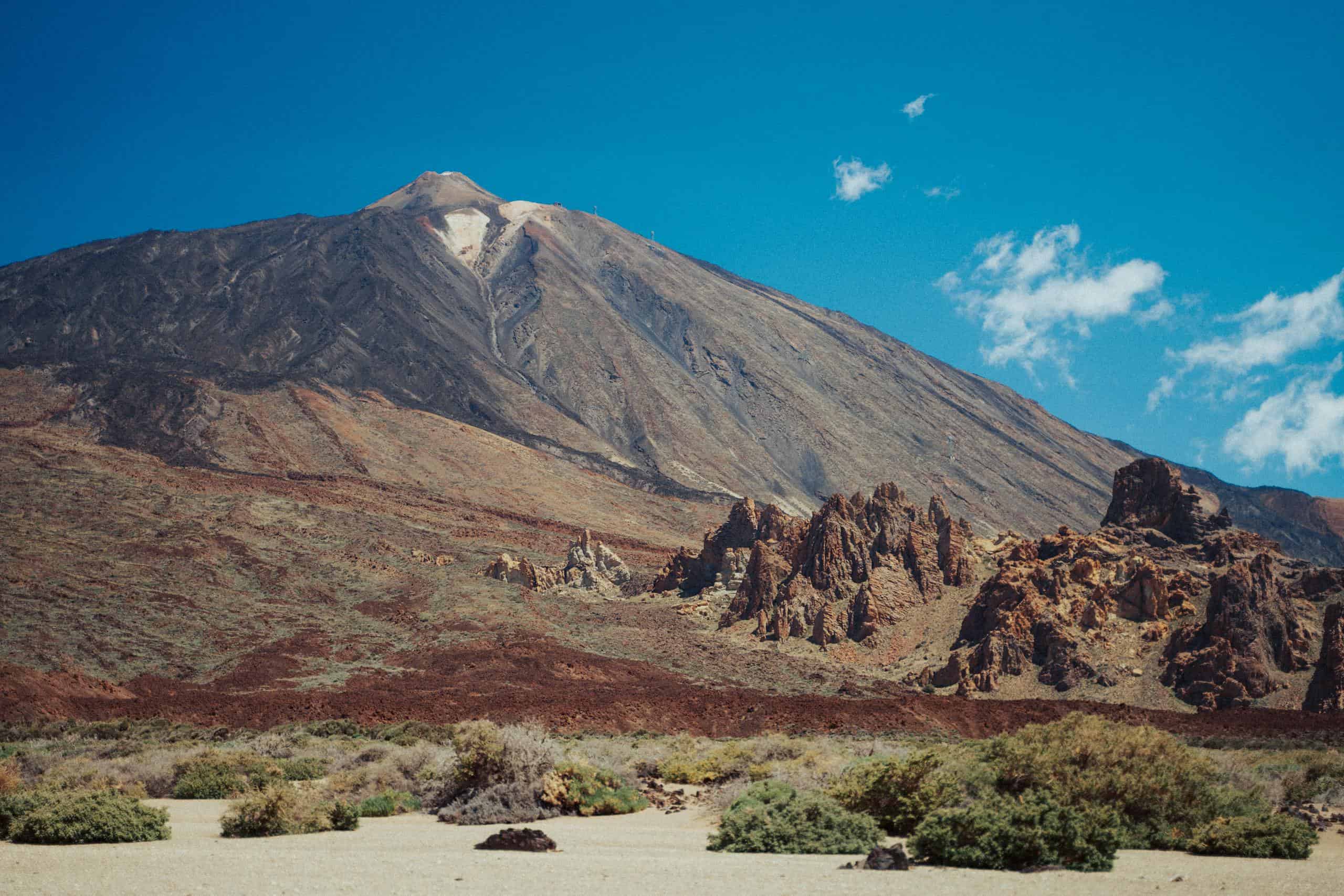 Dramatic view of Mount Teide in Tenerife with clear blue skies, showcasing volcanic landscape.